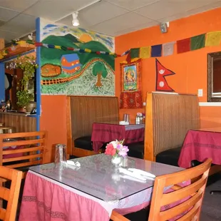 a dining area with tables and chairs