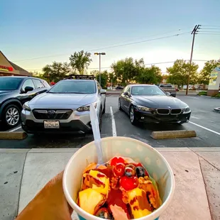 a person holding a bowl of fruit
