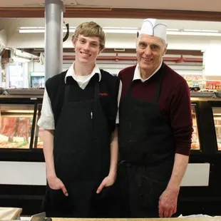 two men standing in front of a counter