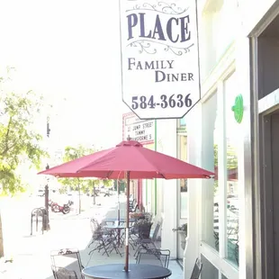 a patio with tables and chairs