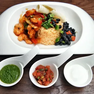 a plate of food with rice, beans, and vegetables