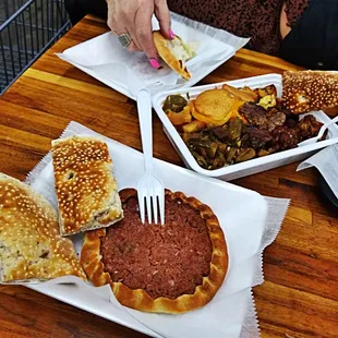a person eating a burger and a sandwich