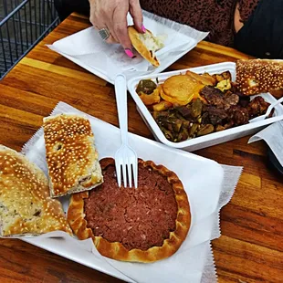 a person eating a burger and a sandwich