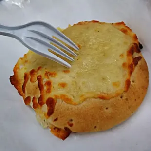 a piece of pizza with a fork sticking out of it