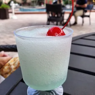 a drink with a cherry in it