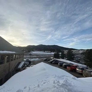 a parking lot with cars in the snow