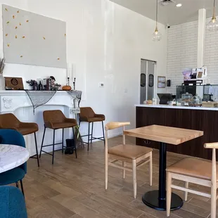 Inside the shop, at least half a dozen tables plus a couch.