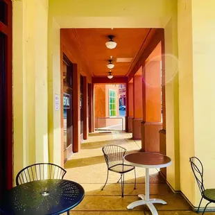 a hallway with tables and chairs