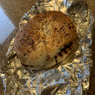 Toasted everything bagel with cream cheese, avocado and tomato.
