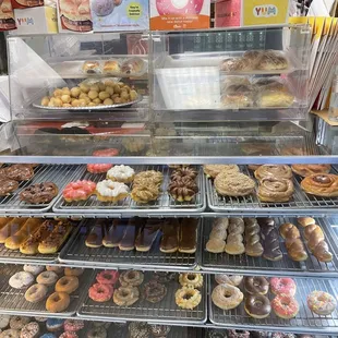 a variety of donuts in a display case