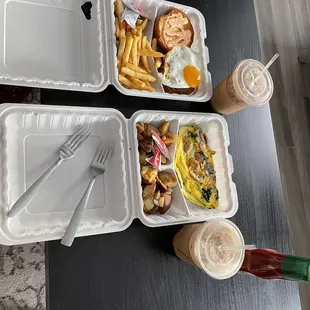 three takeout trays of food on a table