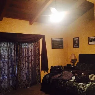 Cedar Room King size bed and access to back patio through the double doors behind the curtains. Very quiet for a sound sleep!!