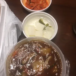 Tangsuyuk dipping sauce, sweet sour pickled white radish, and cabbage kimchi