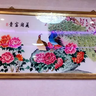 The peacocks and flowers in the painting are gorgeous.