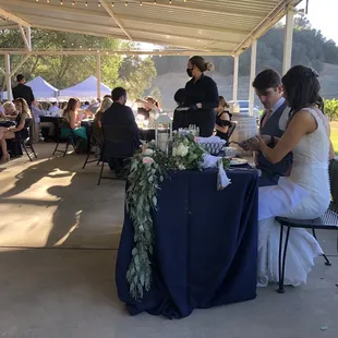 a bride and groom sharing a meal