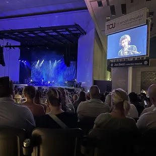 a crowd of people watching a concert