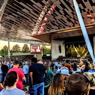 a large crowd of people at an outdoor concert