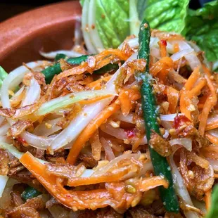 a plate of food with lettuce and carrots