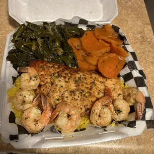 Salmon and shrimp over rice yams, greens