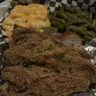 a plate of fried chicken, green beans, and macaroni and cheese