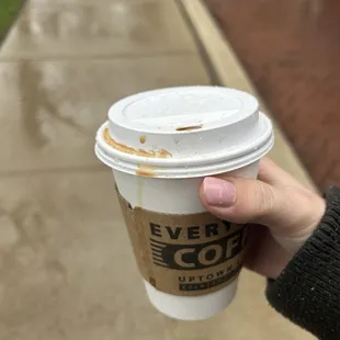 a person holding a cup of coffee