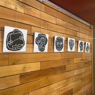 a wood paneled wall with drawings on it