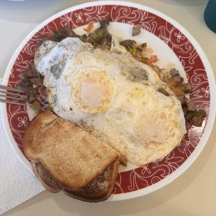Eggs, with hash browns mixed with veggies and toast
