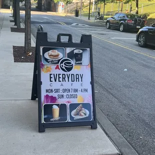 a sidewalk sign on a sidewalk