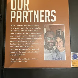 a picture of a couple and a sign that says our partners