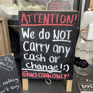 a sign that reads attention we do not carry any change