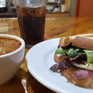 Roast beef and provolone on toasted sourdough bread, with a cup of pizza soup.