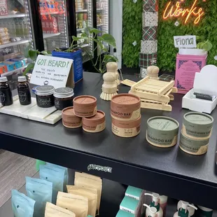 Fancy bath products in front of instagrammable neon and greenery "Everyday Works" sign.