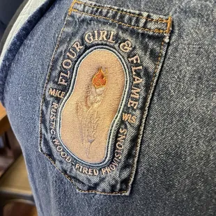 Embroidered denim apron.