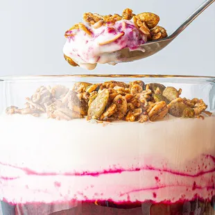 a spoon full of granola and yogurt