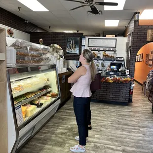 a woman standing in a bakery