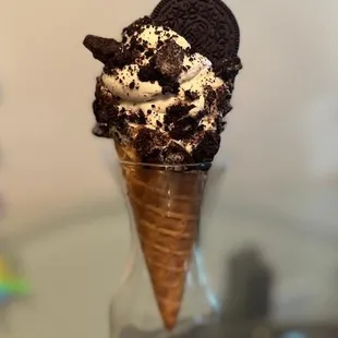 an ice cream cone with oreo cookies in it
