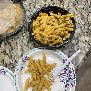 a plate of pasta and a bowl of macaroni and cheese