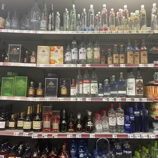 a shelf full of alcohol bottles