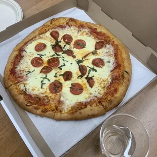 Pepperoni pizza with extra basil and cheese