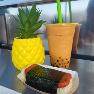 a hot dog and a pineapple drink