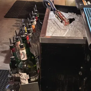 Soda Gun laying on the ice that is being used in drinks.