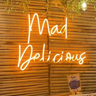 a neon sign that says mad delicious