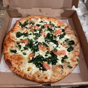 White pie with garlic, spinach tomato and ricotta