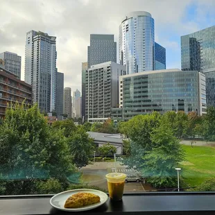 Cheddar &amp; Dill Scone, iced Pumpkin Spice Latte, and a beautiful view of the city. (Photo taken at CitizenM South Lake Union Hotel)