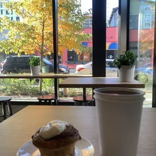 Large hot coffee and cinnamon bun on a cold day in Seattle