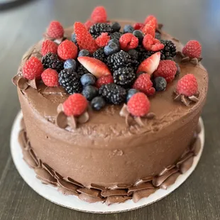 a chocolate cake with berries on top