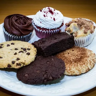 a plate of cookies and cupcakes