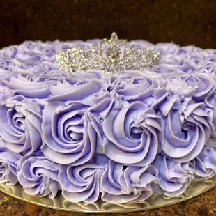 a purple rose cake with a tia on top