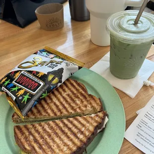 Pressed turkey pesto sandwich with avocado and iced matcha latte with extra agave