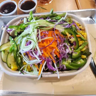 My custom meal with chicken, noodles, rice and many fresh fresh fresh veggies. We tried the sauces on the side .